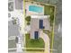Aerial view of the property featuring the in-ground pool, solar panels, and plenty of parking at 721 Mendoza Dr, Orlando, FL 32825