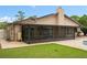 Spacious backyard featuring a covered, screened-in patio with outdoor furniture and well-maintained lawn at 721 Mendoza Dr, Orlando, FL 32825