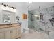 Beautiful bathroom featuring double vanity and frameless glass shower with marble tile at 721 Mendoza Dr, Orlando, FL 32825