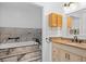 Modern bathroom with marble tile, vanity with granite countertop, and built-in cabinet at 721 Mendoza Dr, Orlando, FL 32825