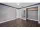 Bedroom with dark wood laminate flooring, ceiling fan, walk-in closet and grey walls at 721 Mendoza Dr, Orlando, FL 32825