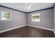Neutral bedroom with dark floors, base trim and crown moulding, plus two windows at 721 Mendoza Dr, Orlando, FL 32825