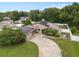 Charming home with solar panels, long driveway, mature landscaping, and a white fence for privacy at 721 Mendoza Dr, Orlando, FL 32825