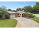 Charming single-story home featuring a two-car garage, front yard landscaping and solar panels at 721 Mendoza Dr, Orlando, FL 32825