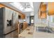 Modern kitchen featuring stainless steel appliances, light wood cabinets, and an abundance of storage at 721 Mendoza Dr, Orlando, FL 32825