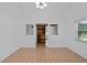 Open-concept room featuring a sliding barn door, tile flooring and white walls at 721 Mendoza Dr, Orlando, FL 32825