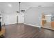 Spacious living room leading into the kitchen with hardwood floors and stone fireplace at 721 Mendoza Dr, Orlando, FL 32825