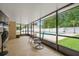 Relaxing screened-in patio with chairs and a view of the sparkling pool and green backyard at 721 Mendoza Dr, Orlando, FL 32825