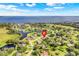 Picturesque neighborhood features beautiful homes surrounded by lush trees, green lawns, and tranquil waters at 7350 Spring Mountain Ln, Yalaha, FL 34797