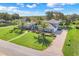 Spacious single-story home with lush lawn, mature palms, and a circular driveway at 7350 Spring Mountain Ln, Yalaha, FL 34797