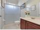 Bathroom features a shower with sliding glass doors, toilet, vanity with sink and mirror at 7350 Spring Mountain Ln, Yalaha, FL 34797