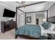 Bedroom with a dark four-poster bed, television and dresser; view of walk-in closet at 7350 Spring Mountain Ln, Yalaha, FL 34797