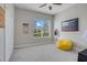 Bedroom features a ceiling fan, large window, closet and yellow beanbag chair at 7350 Spring Mountain Ln, Yalaha, FL 34797
