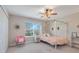 Charming bedroom with a canopy bed, window, and pastel accents, creating a whimsical and inviting space at 7350 Spring Mountain Ln, Yalaha, FL 34797