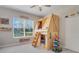 Bright bedroom features a custom-built wooden bunk bed with fun design and natural light at 7350 Spring Mountain Ln, Yalaha, FL 34797