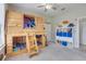 Bright bedroom features a custom-built wooden bunk bed and shelving with fun design at 7350 Spring Mountain Ln, Yalaha, FL 34797