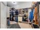 Large walk-in closet with ample shelving and hanging space for organized storage at 7350 Spring Mountain Ln, Yalaha, FL 34797