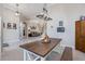 Open concept dining area that provides a view of the living room in a naturally lit space at 7350 Spring Mountain Ln, Yalaha, FL 34797
