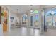 Bright foyer with a decorative glass front door, transom windows, and tile flooring at 7350 Spring Mountain Ln, Yalaha, FL 34797