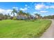 Charming single-story home with a well-maintained lawn, mature trees, and inviting curb appeal at 7350 Spring Mountain Ln, Yalaha, FL 34797