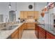 Large kitchen featuring granite countertops, stainless appliances, and an island with a sink at 7350 Spring Mountain Ln, Yalaha, FL 34797