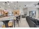 Open kitchen with breakfast bar, granite countertops, stainless steel appliances, and adjacent dining area at 7350 Spring Mountain Ln, Yalaha, FL 34797