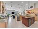 Spacious kitchen featuring an island, breakfast bar, and stainless steel appliances at 7350 Spring Mountain Ln, Yalaha, FL 34797