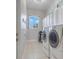 Functional laundry room equipped with modern washer and dryer, plus ample storage at 7350 Spring Mountain Ln, Yalaha, FL 34797