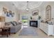 Comfortable living room featuring a fireplace, large windows, and access to the outdoors at 7350 Spring Mountain Ln, Yalaha, FL 34797