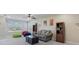 Upstairs living room features comfortable sofa and chairs, built-in shelving, and neutral carpet at 7350 Spring Mountain Ln, Yalaha, FL 34797