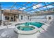 Stunning screened-in pool with integrated hot tub, providing a luxurious and private outdoor experience at 7350 Spring Mountain Ln, Yalaha, FL 34797