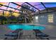 Inviting screened pool area with a hot tub, lounge chairs, and atmospheric string lights for evening relaxation at 7350 Spring Mountain Ln, Yalaha, FL 34797