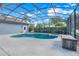 Relaxing screened-in pool and spa area with lush landscaping, perfect for outdoor enjoyment and entertaining at 7350 Spring Mountain Ln, Yalaha, FL 34797