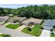 Aerial view of well-maintained homes featuring lush landscaping and patterned driveways in a quiet neighborhood at 8377 Se 177Th Bartram Loop, The Villages, FL 32162