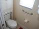 Toilet under window with overhead storage and a grab bar at 8377 Se 177Th Bartram Loop, The Villages, FL 32162