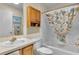Cozy bathroom featuring a vanity, toilet, and a tub with a decorative shower curtain at 8377 Se 177Th Bartram Loop, The Villages, FL 32162