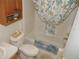 Bathroom featuring a bathtub with shower, patterned curtain, toilet and vanity with storage at 8377 Se 177Th Bartram Loop, The Villages, FL 32162