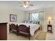 Charming bedroom features a wooden bed frame, ceiling fan, and tile flooring at 8377 Se 177Th Bartram Loop, The Villages, FL 32162