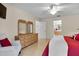 This bedroom has a double dresser with two mirrors over it with access to bathroom and walk-in closet at 8377 Se 177Th Bartram Loop, The Villages, FL 32162