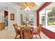 Charming dining area with glass table, wicker chairs, and views of the outdoor scenery at 8377 Se 177Th Bartram Loop, The Villages, FL 32162