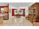 Open concept dining room with bright lighting, tile flooring and a china cabinet at 8377 Se 177Th Bartram Loop, The Villages, FL 32162