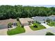 Beautiful aerial view of a well-maintained single-story home with lush landscaping and a long driveway at 8377 Se 177Th Bartram Loop, The Villages, FL 32162