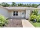 Close up shot of front entrance featuring decorative plantings and an ADT security sign at 8377 Se 177Th Bartram Loop, The Villages, FL 32162