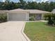 Charming single-story home boasts a well-manicured lawn and decorative driveway, enhancing its curb appeal at 8377 Se 177Th Bartram Loop, The Villages, FL 32162
