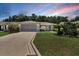 Charming single-story home featuring a well-manicured lawn and a beautifully patterned driveway at 8377 Se 177Th Bartram Loop, The Villages, FL 32162