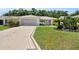 Charming single-story home featuring a well-manicured lawn and a beautifully patterned driveway at 8377 Se 177Th Bartram Loop, The Villages, FL 32162