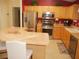 Modern kitchen featuring stainless steel appliances and a breakfast bar with seating at 8377 Se 177Th Bartram Loop, The Villages, FL 32162