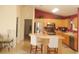 Bright kitchen features stainless steel appliances, tile flooring, red accent wall and a breakfast bar with seating at 8377 Se 177Th Bartram Loop, The Villages, FL 32162