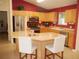 Modern kitchen with stainless steel appliances and a large island featuring barstool seating at 8377 Se 177Th Bartram Loop, The Villages, FL 32162