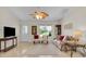 Cozy living room features large window, comfortable seating and ample natural light at 8377 Se 177Th Bartram Loop, The Villages, FL 32162
